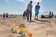 Frans Timmermans, in the center, participates in a beach cleanup with young scouts.