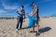 Frans Timmermans, on the left, participates in a beach cleanup with young scouts.