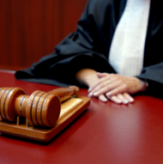 Rechter aan tafel met houten hamer